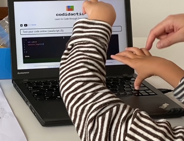 Kid coding on a computer